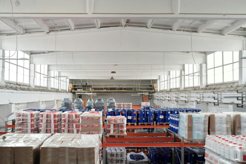 Spacious warehouse interior featuring organized shelves with various stacked pallets.